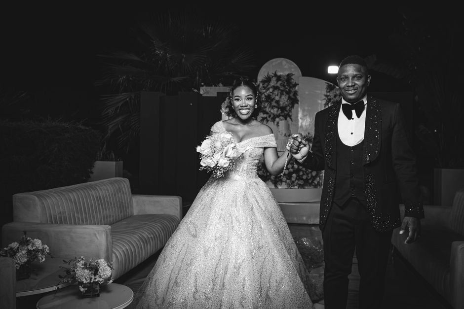 Black and white portrait of a joyful bride and groom at their wedding in Luanda, Angola.
