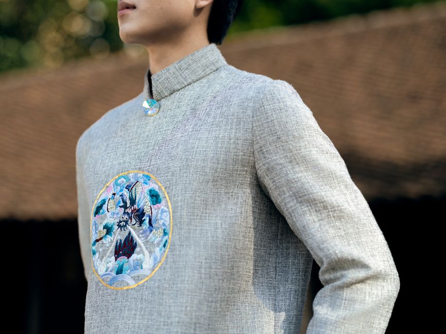 Close up of a traditional embroidered shirt with an Asian motif, outdoors.