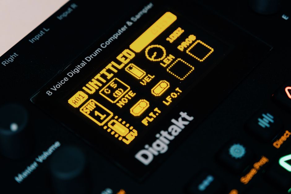 Detailed close-up of the Elektron Digitakt drum machine display showing audio settings and buttons.
