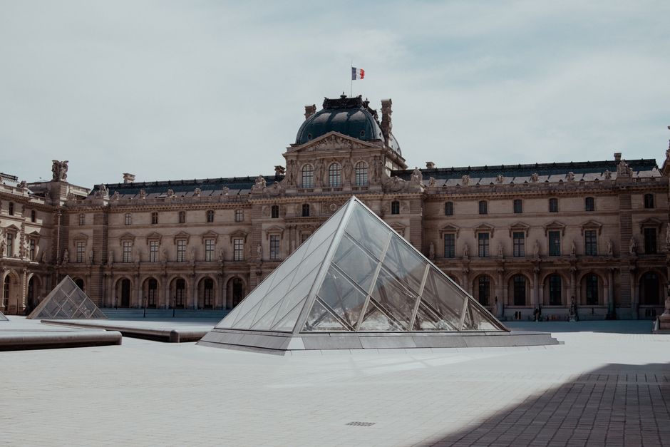 View of the iconic glass pyramid at the Louvre Museum in Paris, France.