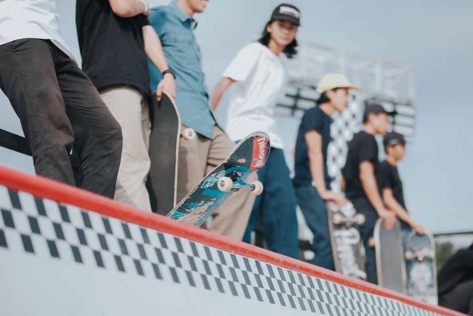Group of young skaters practicing tricks at a skate park ramp in Yogyakarta, Indonesia.